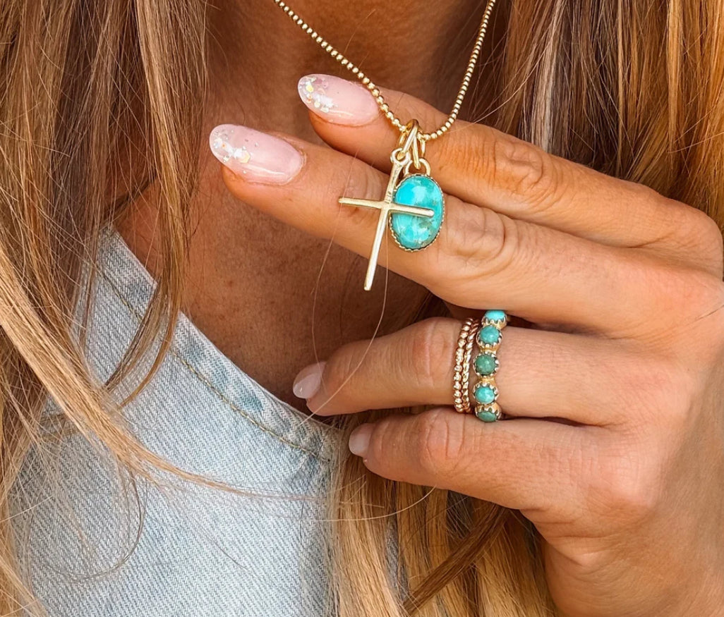 Gold cross necklace by Turnback pony